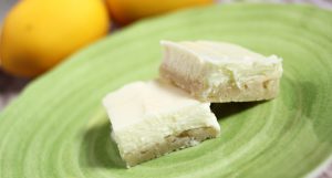 These lemon cheesecake bars only take four ingredients! With a sugar cookie crust it's sweet and tangy and everyone loves it.