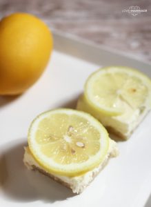 These lemon cheesecake bars only take four ingredients! With a sugar cookie crust it's sweet and tangy and everyone loves it.