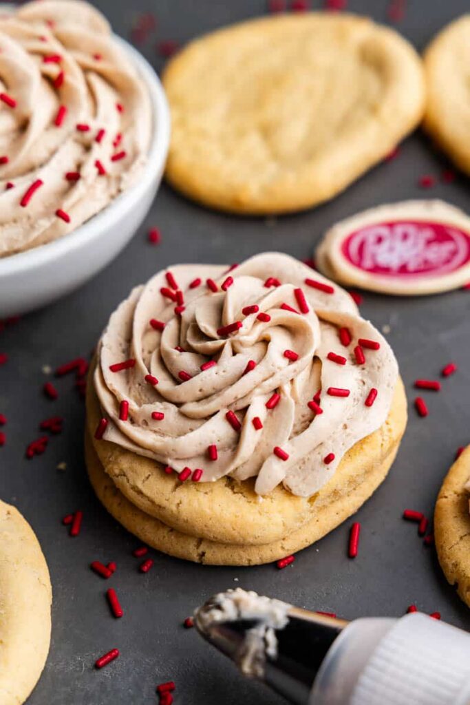 Smooth homemade Dr Pepper frosting swirled on top of a rich cookie.
