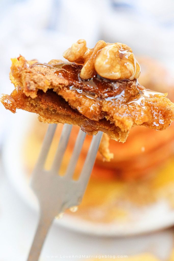 Close up of bite of pumpkin pancake on a fork.